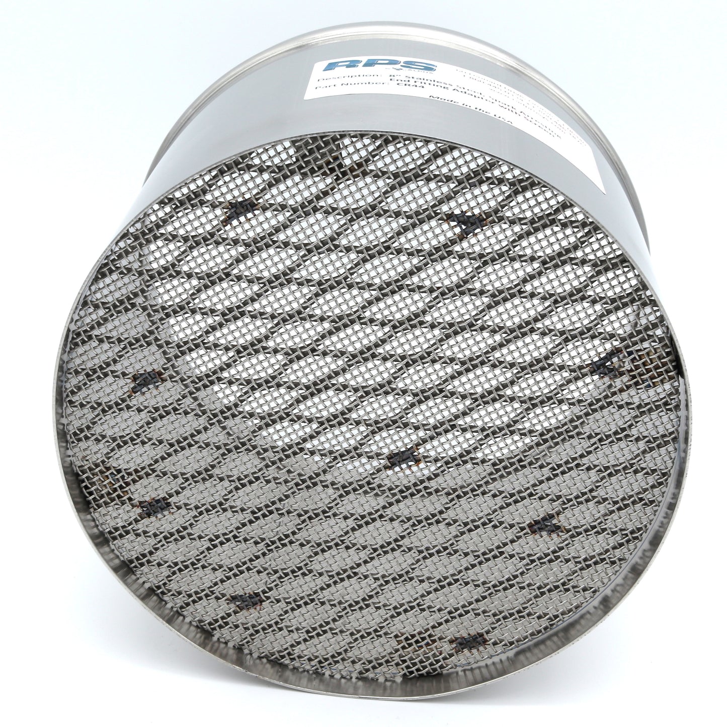 Round metallic filter with textured surface on a white background