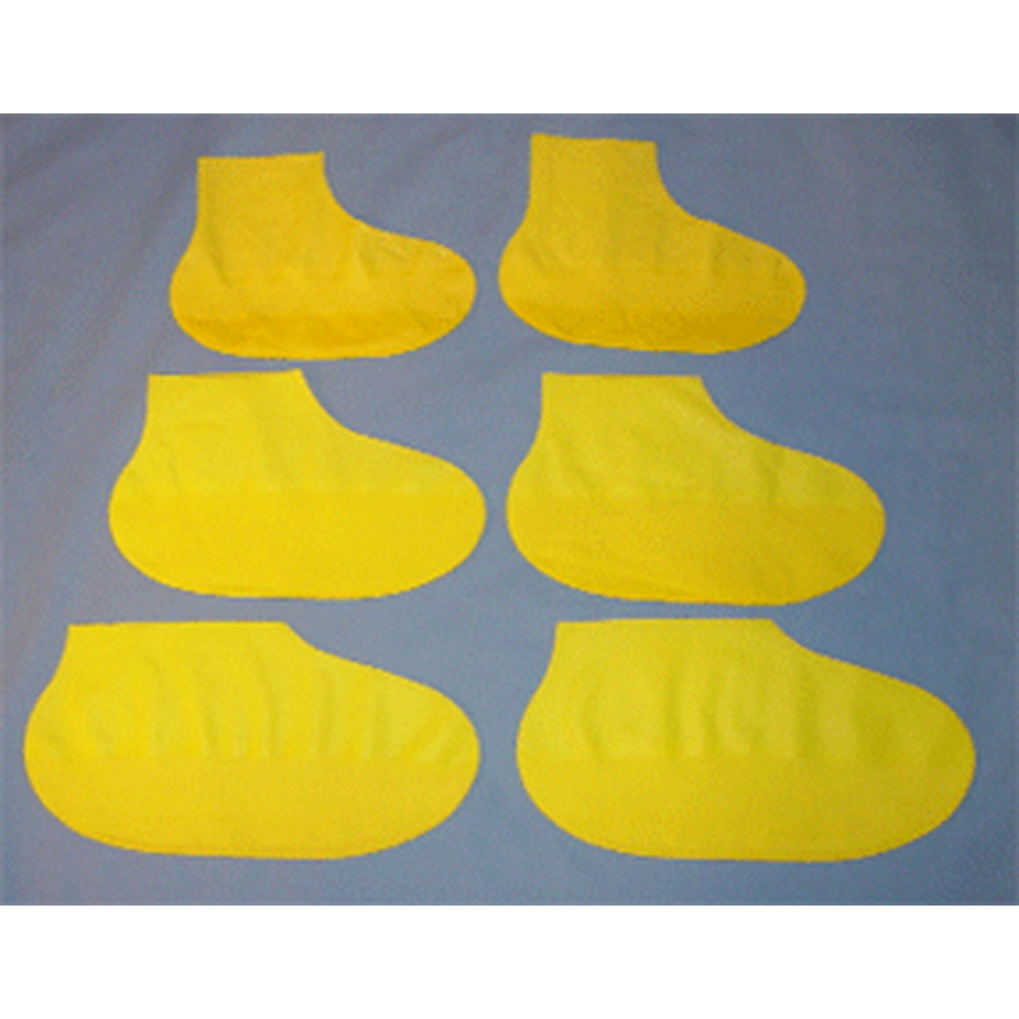 Set of six yellow shoe covers on a gray background