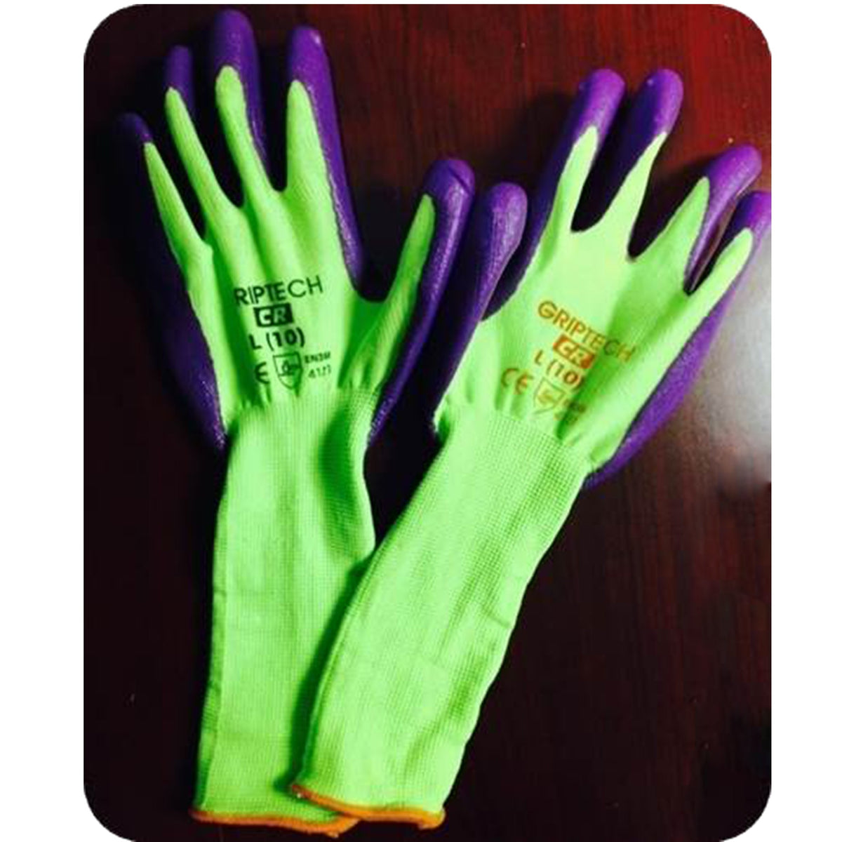 A pair of GRIPTECH brand work gloves with a bright neon green knit body and purple rubberized palms and backs, displayed on a dark wooden surface.

GLOVE-96B-YW