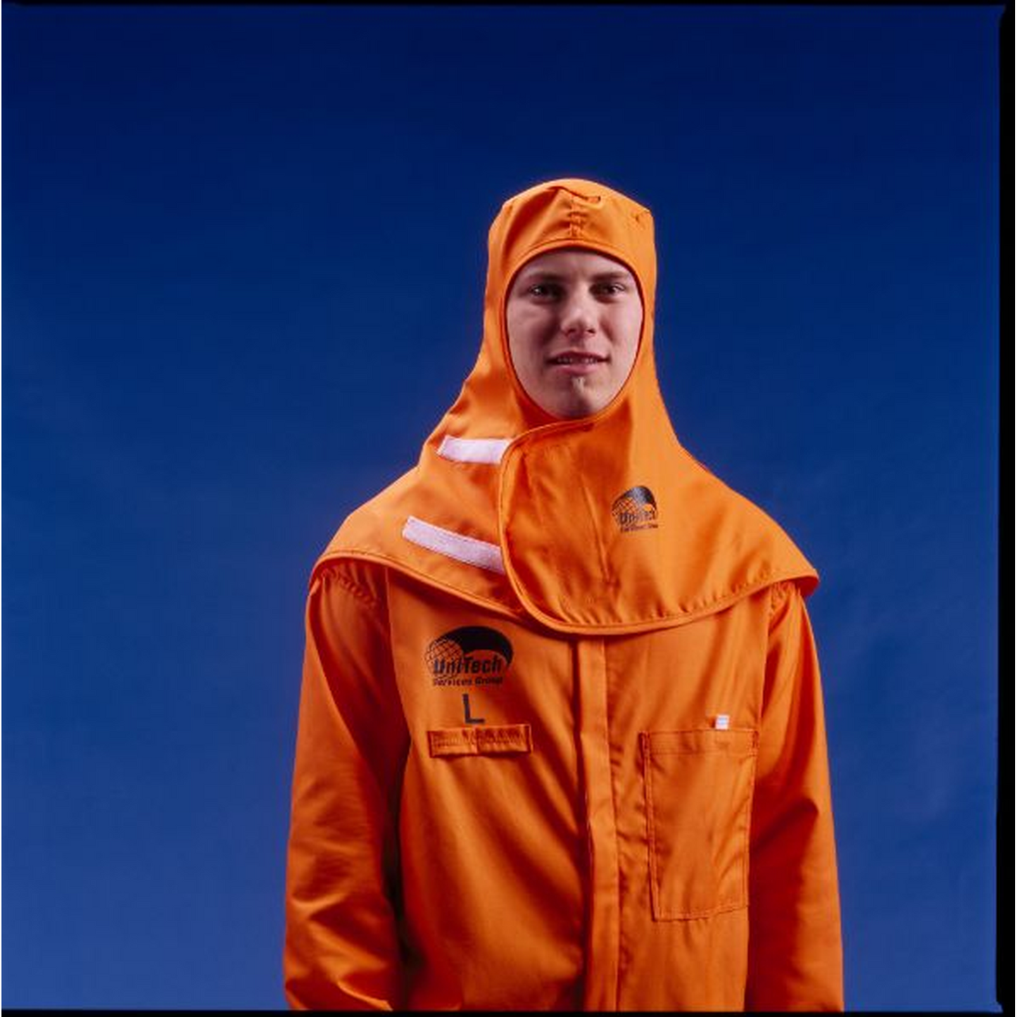 Person wearing an orange coverall with a blue background