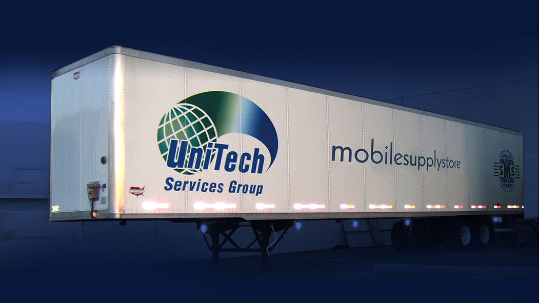 Trailer truck with UniTech Services Group logo on a dark background