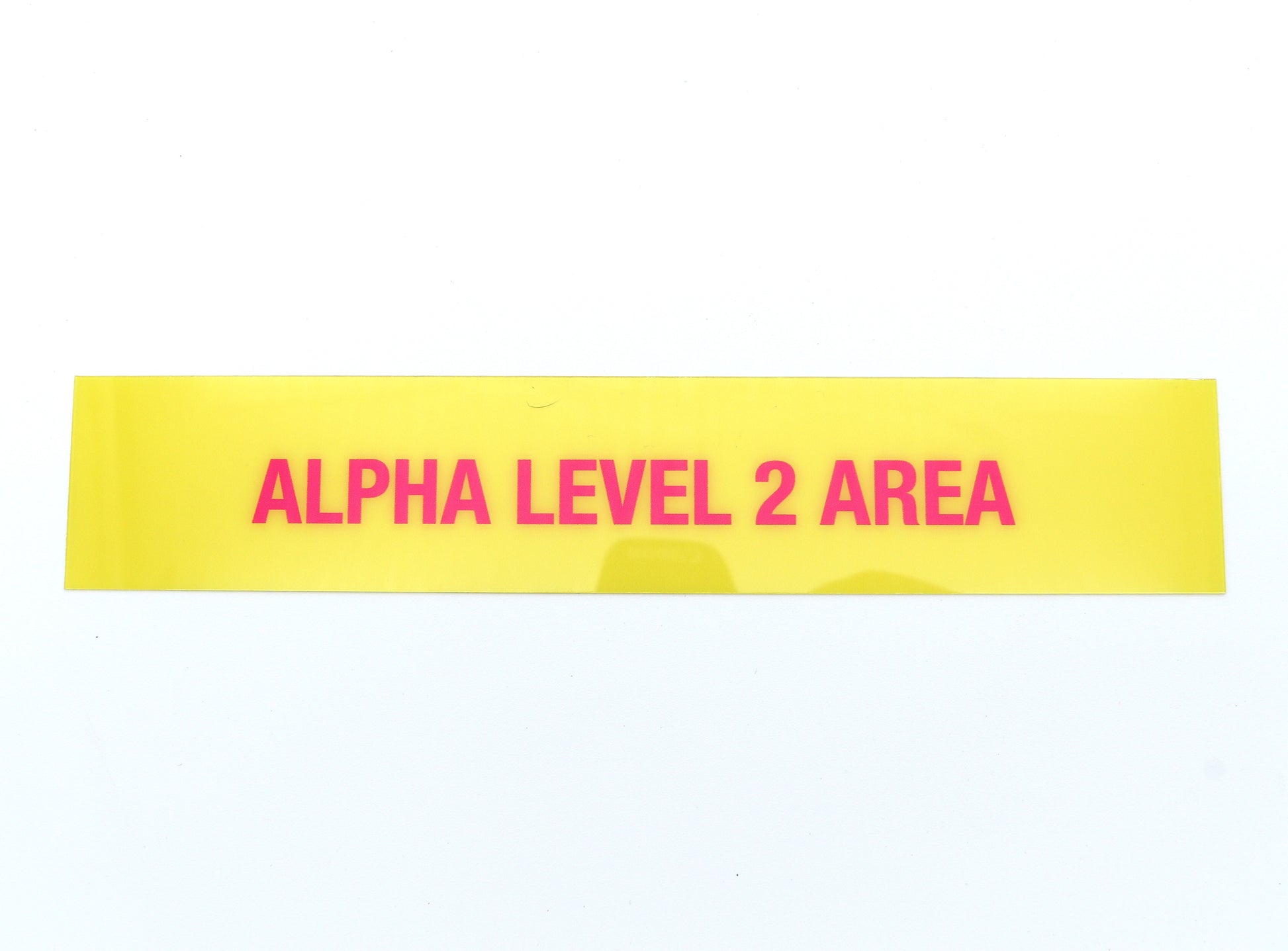 Yellow band with pink text 'ALPHA LEVEL 2 AREA' on a white background