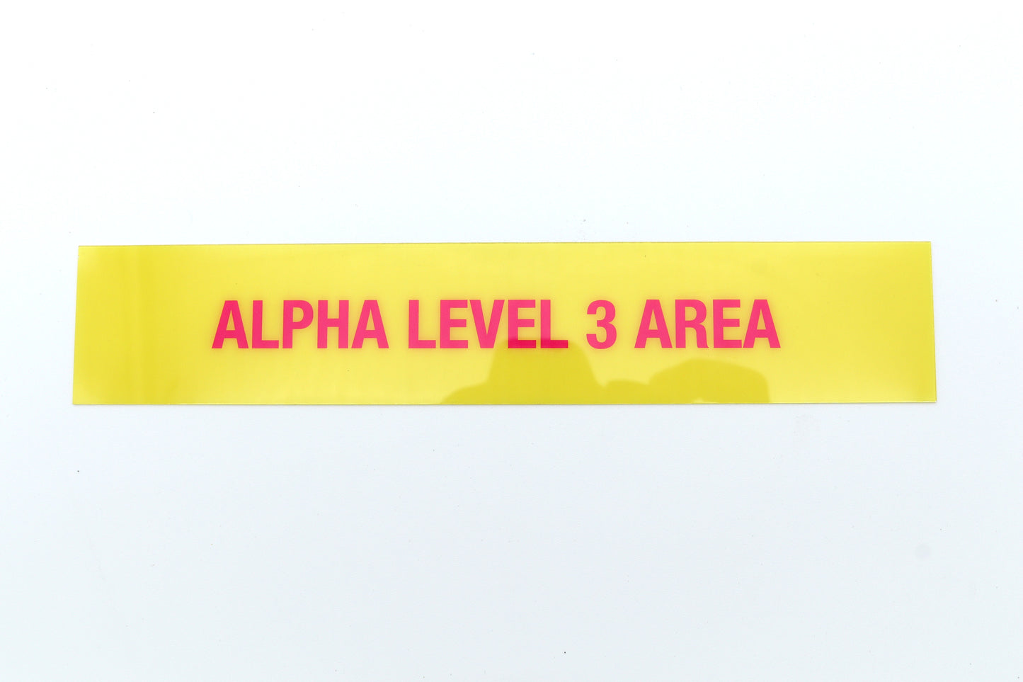 Yellow label with 'ALPHA LEVEL 3 AREA' text on a white background