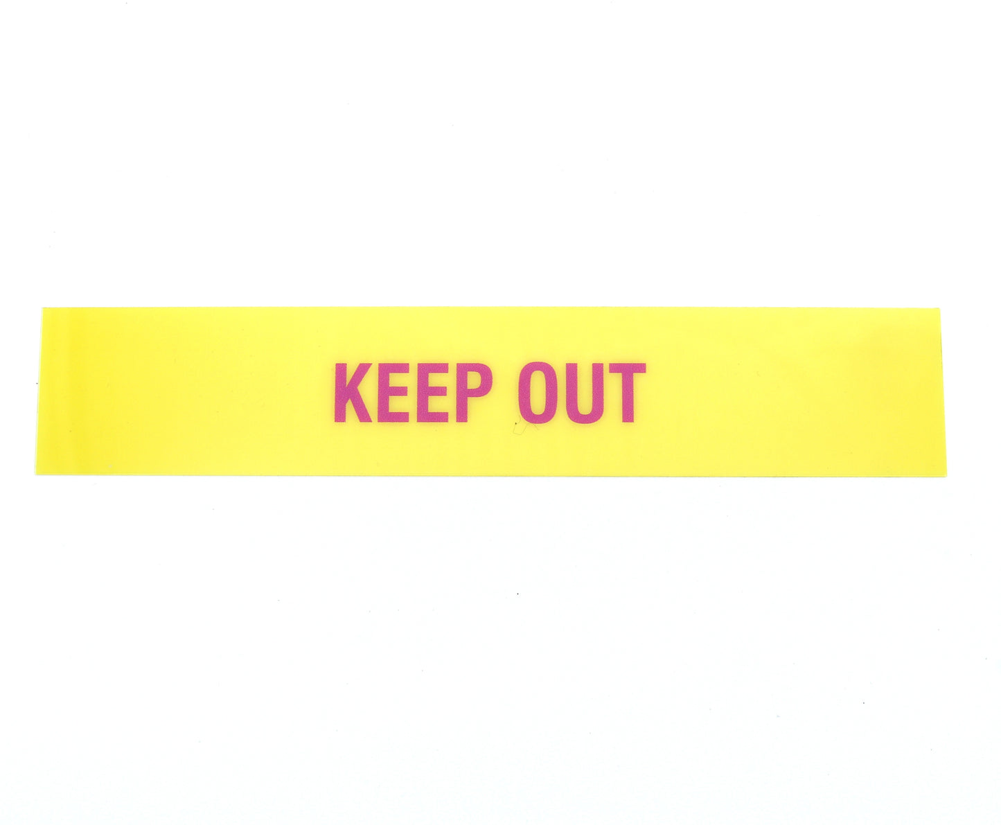 Yellow warning label with 'KEEP OUT' text on a white background
