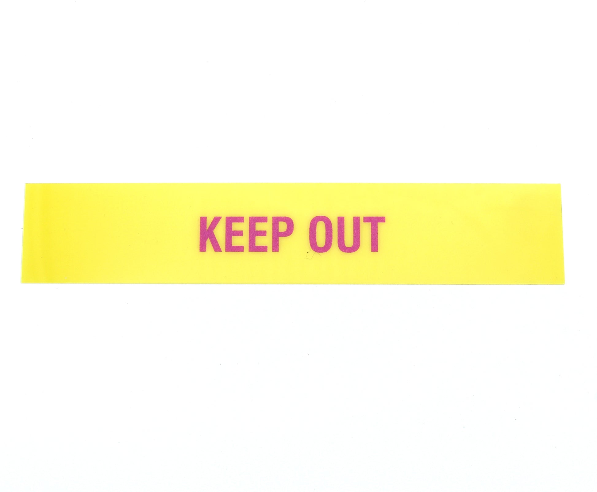 Yellow warning label with 'KEEP OUT' text on a white background