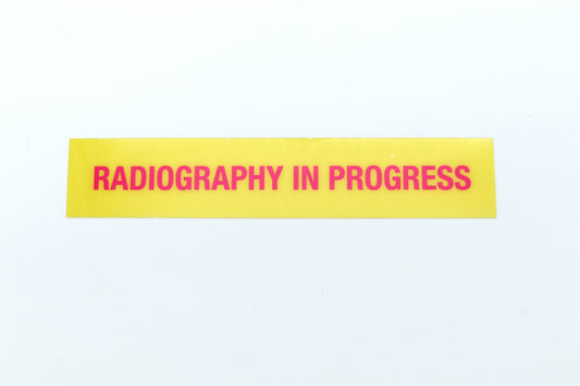 Yellow sign with 'Radiography in Progress' text on a white background