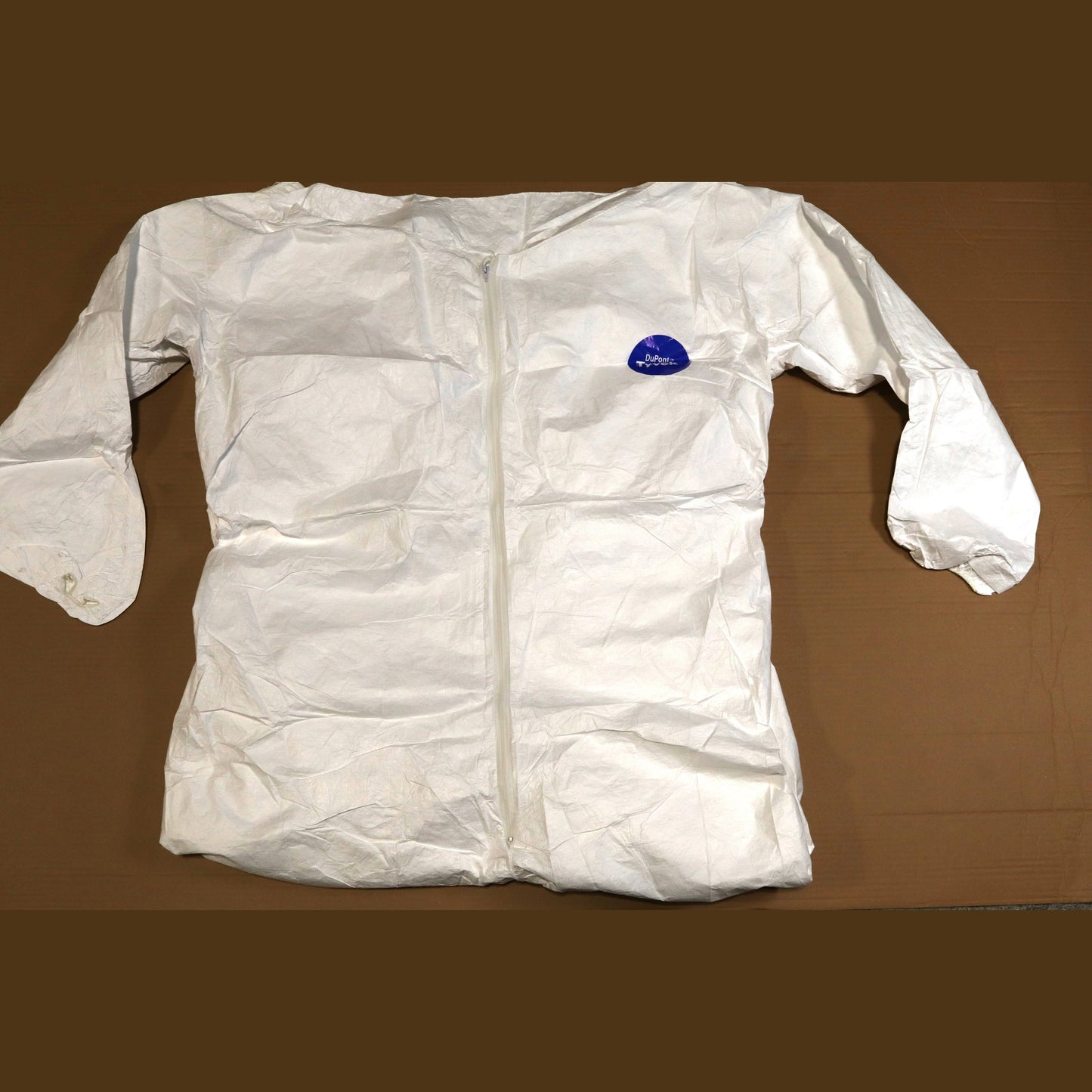 White protective suit with a blue label on a brown background