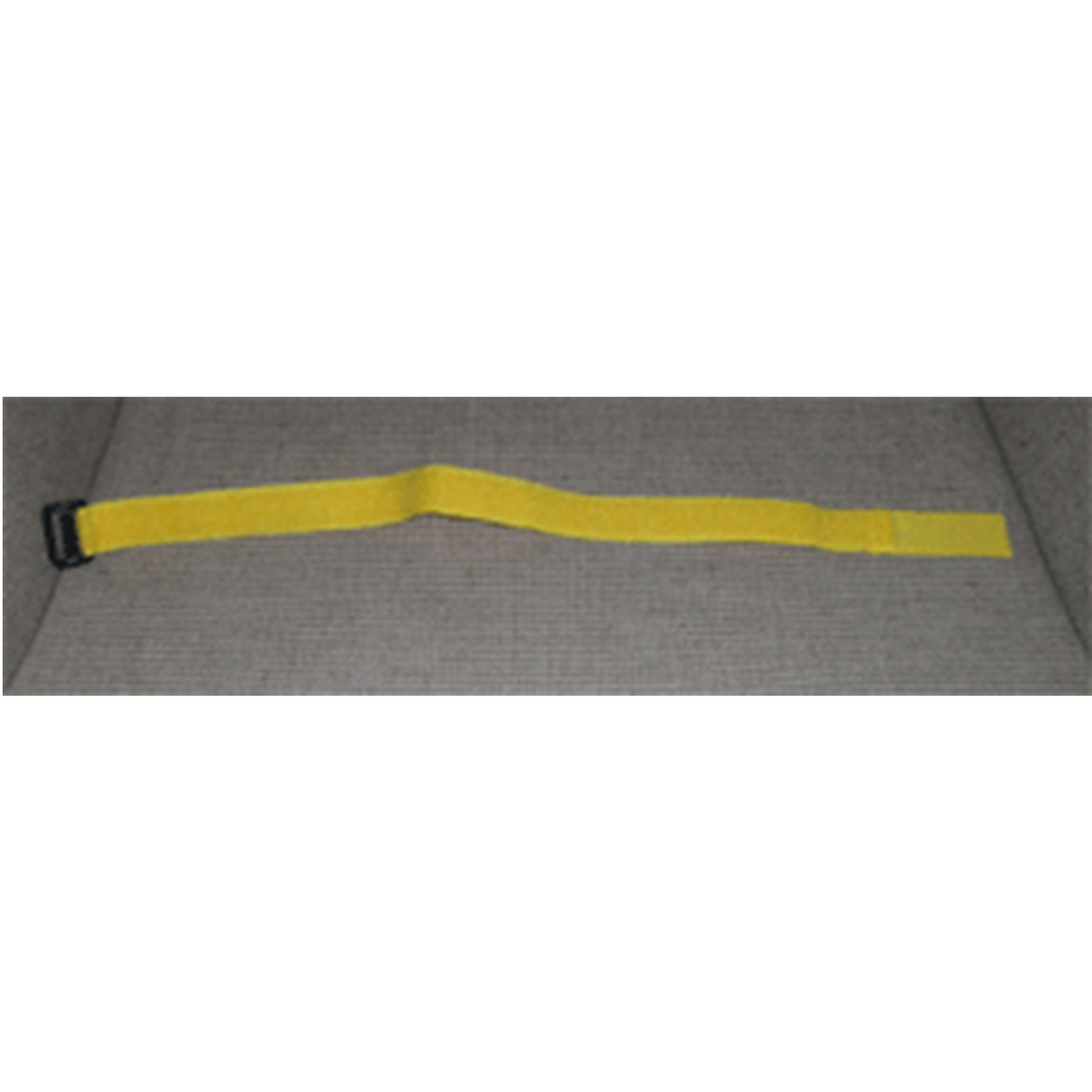 Yellow strap with a black buckle on a gray background