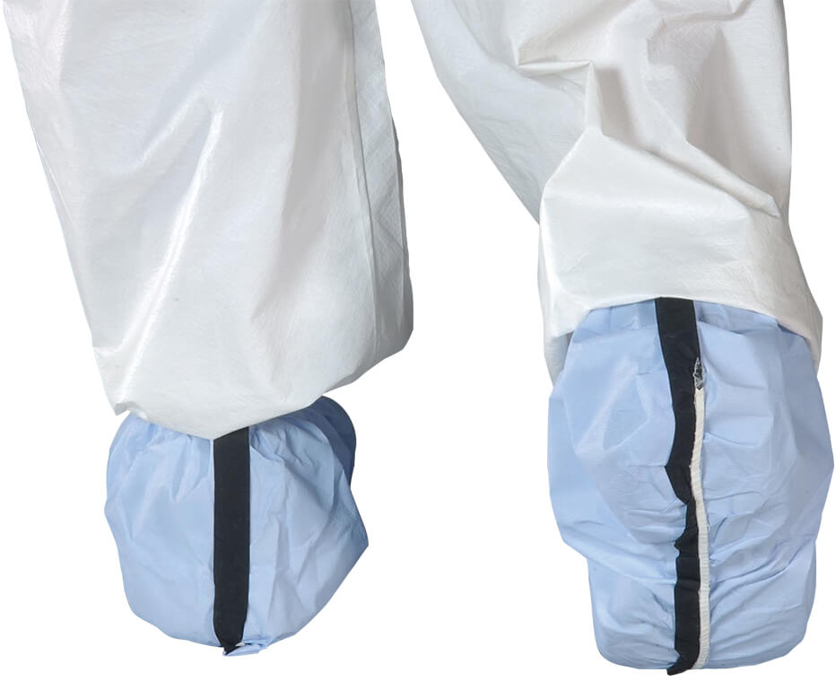 Light blue shoe covers with black seams worn over white pants on a white background