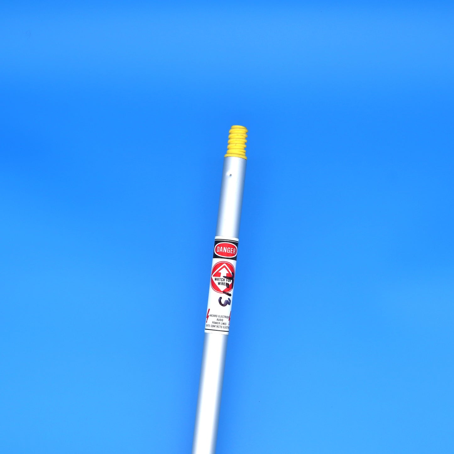 Adjustable mop handle with a warning label on a blue background