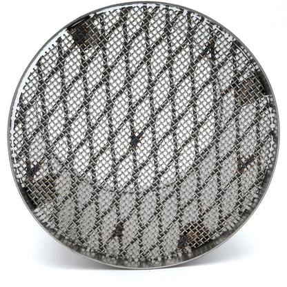 Round metallic mesh filter on a white background