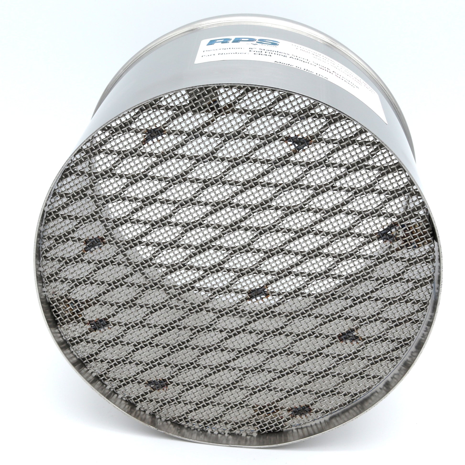 Round metallic filter with textured surface on a white background