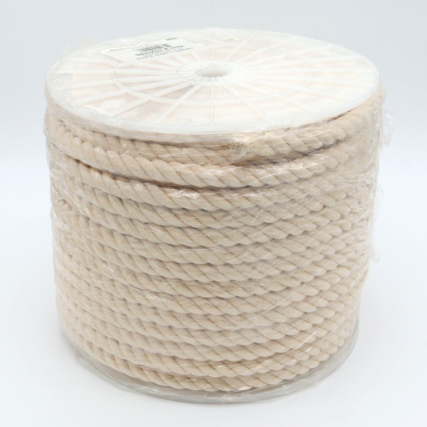 Spool of beige rope on a white background
