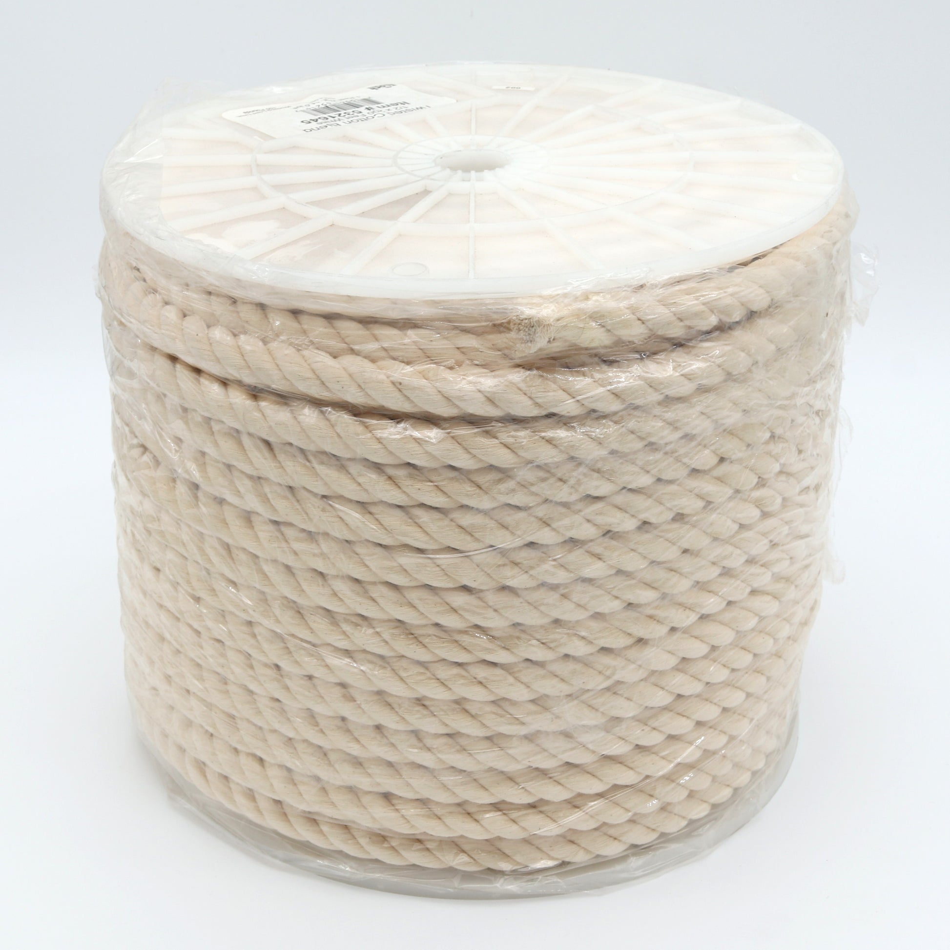 Spool of beige rope on a white background