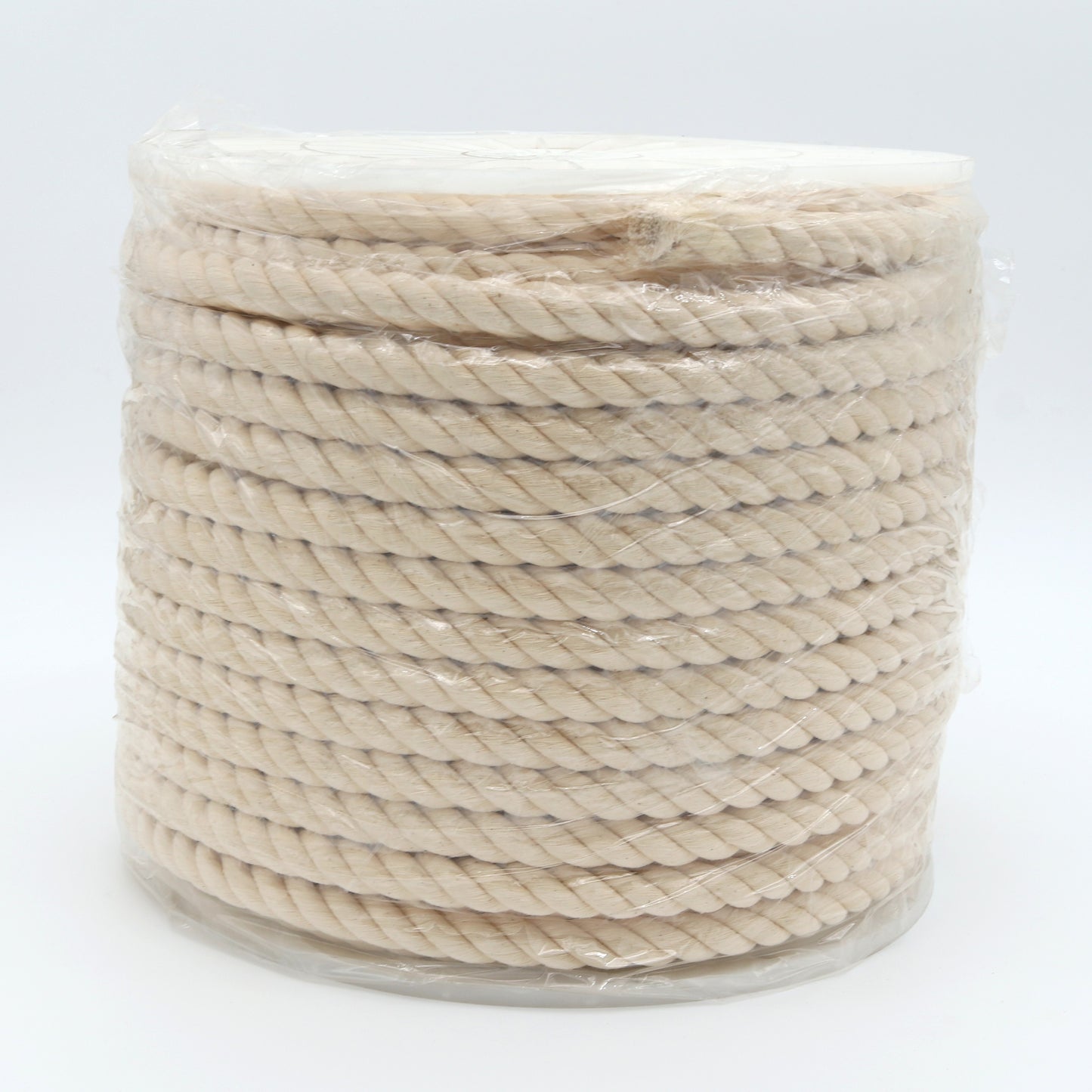 Spool of beige rope on a white background