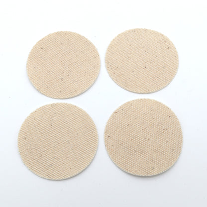 Four beige round smears on a white background
