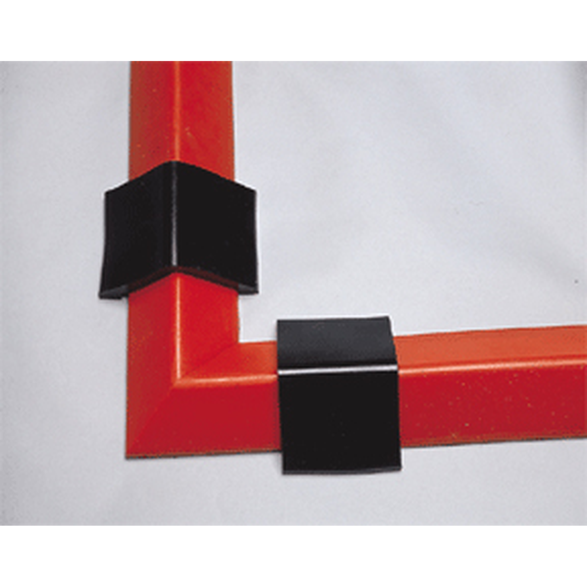 Black corner protectors on a red frame against a white background