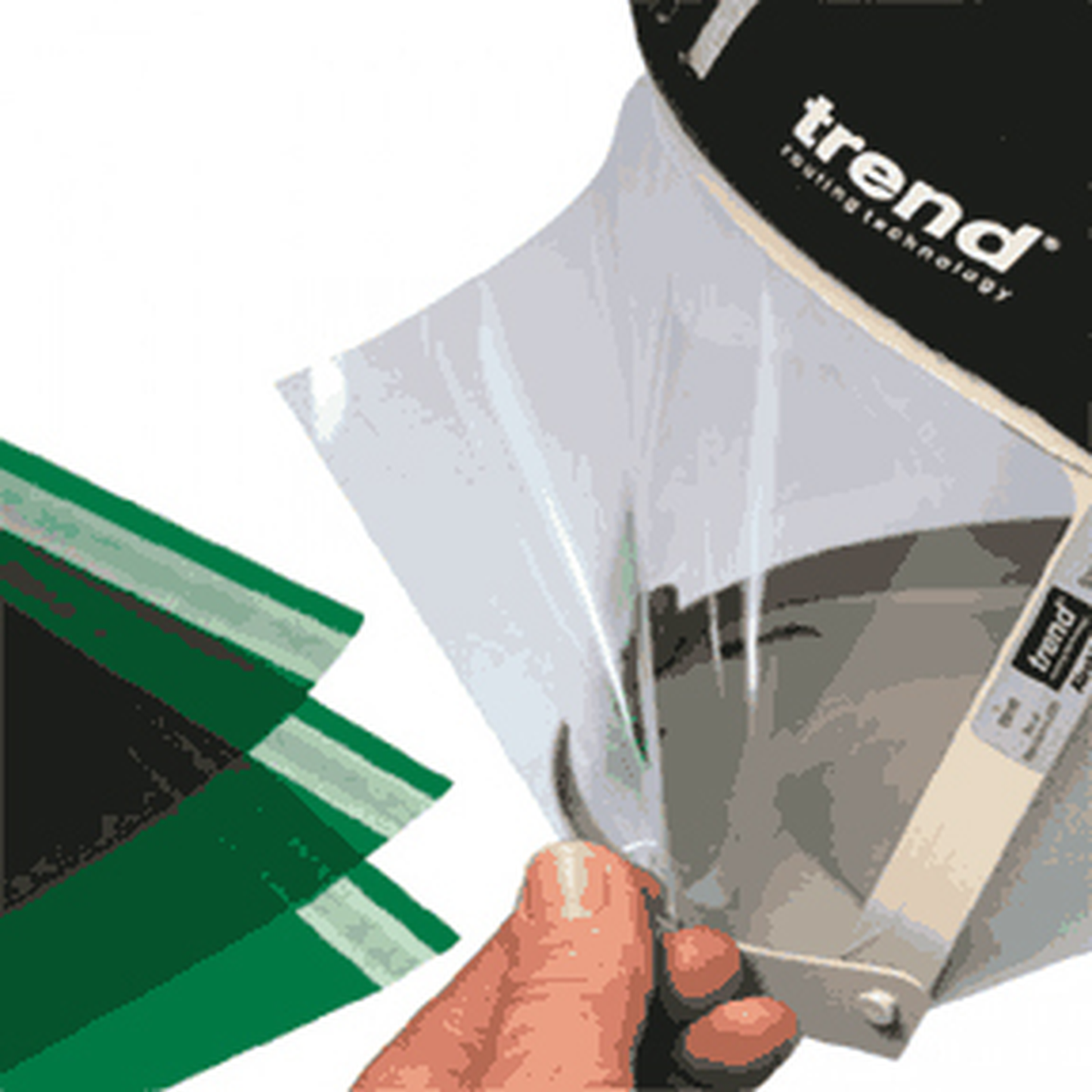 Hand holding a clear plastic bag with green and black items, branded 'trend'.