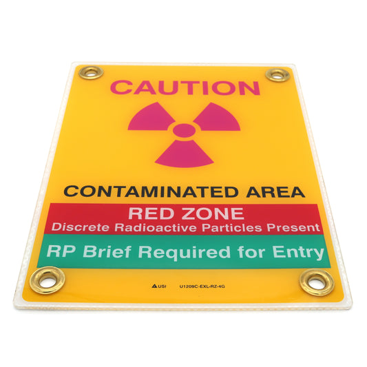 Radiation warning sign with caution and red zone text on a yellow background