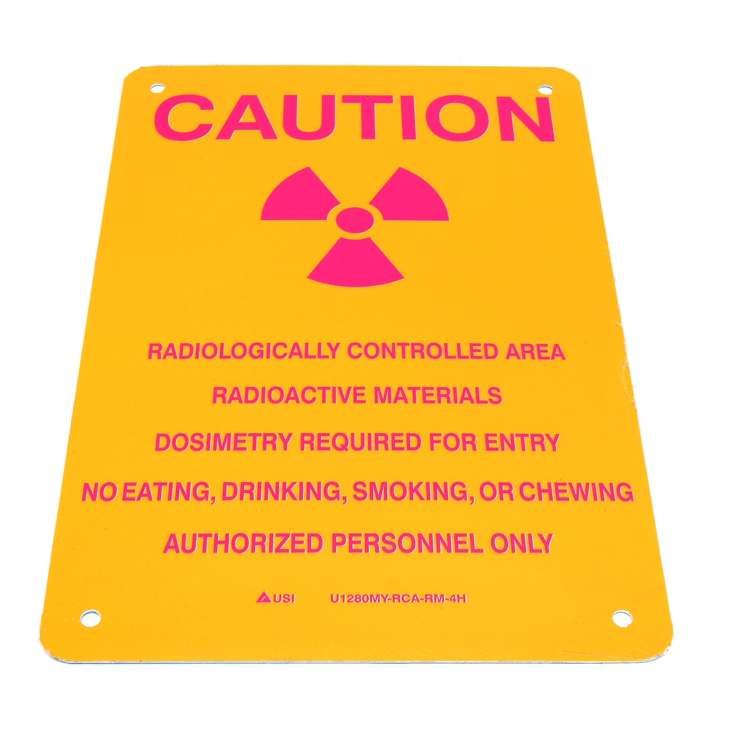 Caution sign with radiation symbol and text on a yellow background