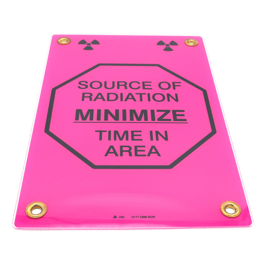 Pink radiation warning sign with text 'Source of Radiation Minimize Time in Area' on a white background