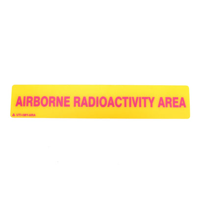 Yellow warning label with 'AIRBORNE RADIOACTIVITY AREA' text on a white background