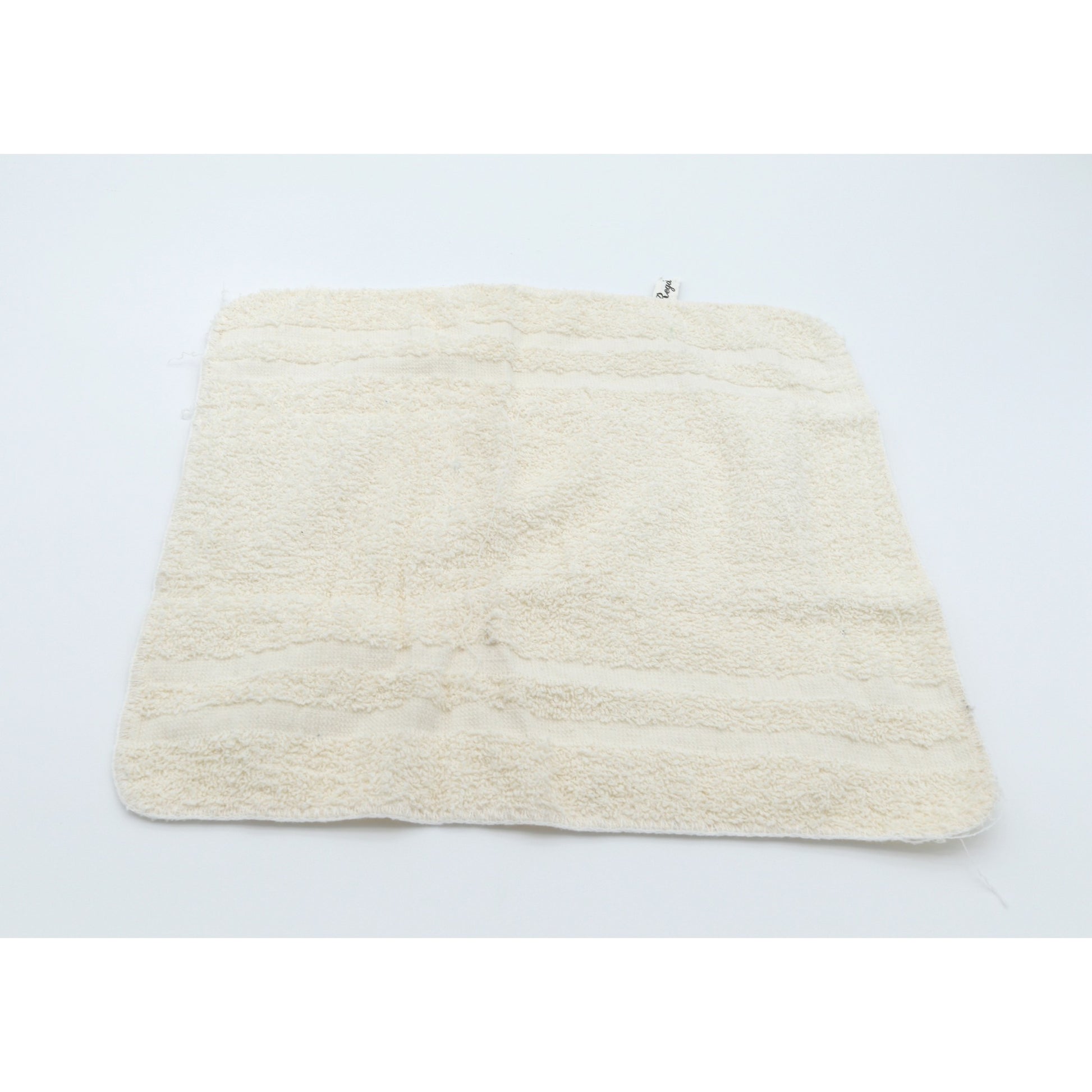 Beige washcloth on a light gray background