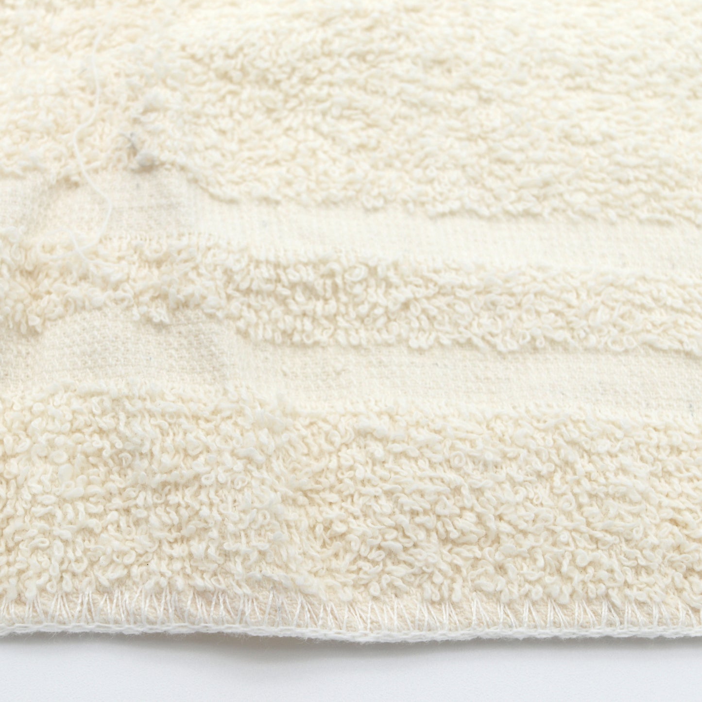 Close-up of a textured white rag on a white background