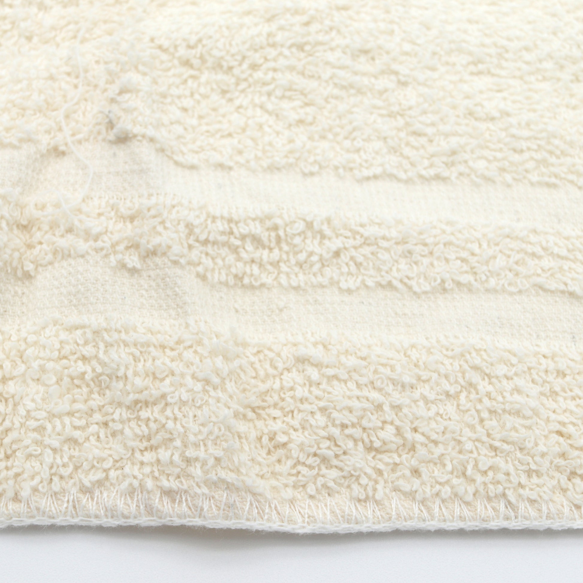 Close-up of a textured white rag on a white background