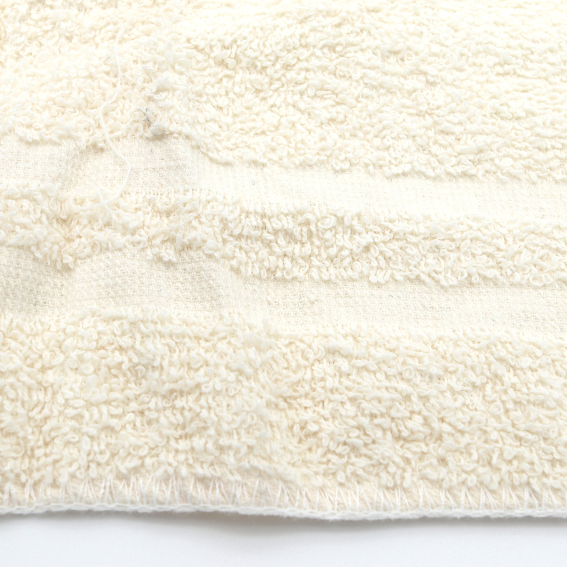 Close-up of a textured white fabric on a white background