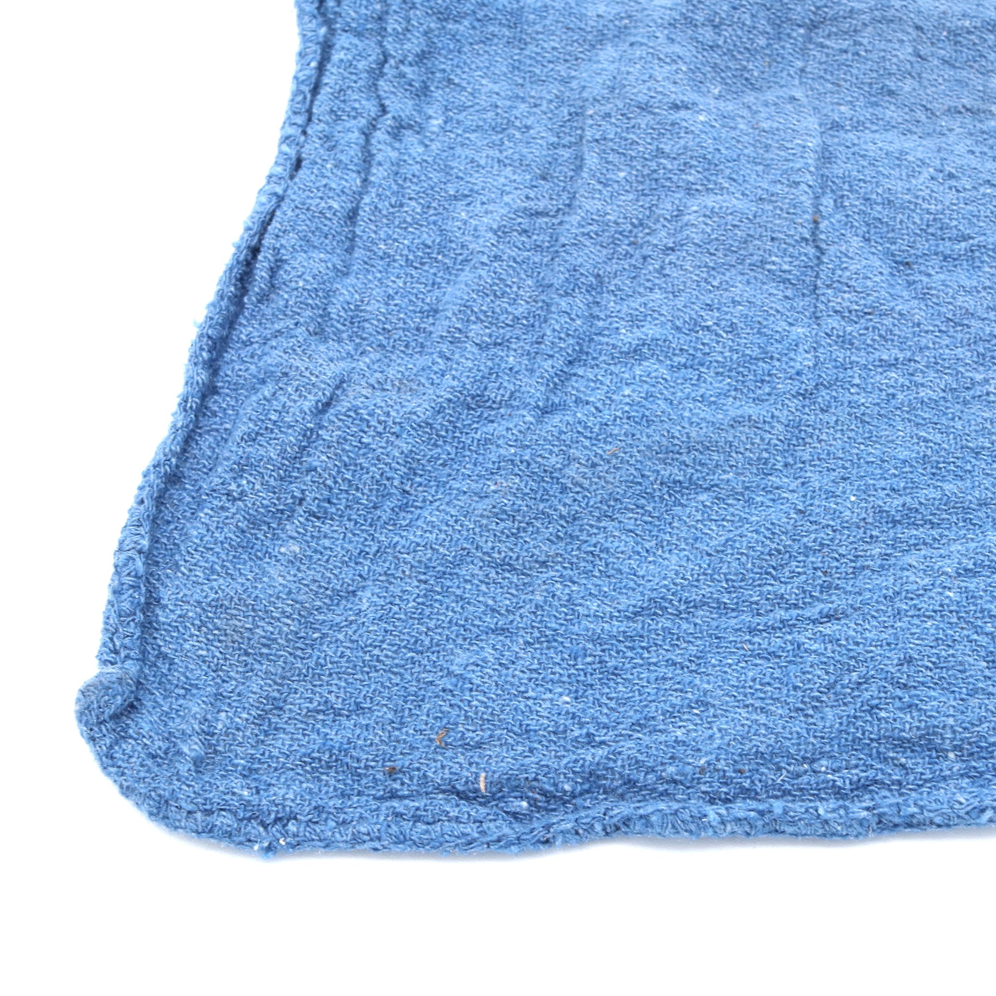 Close-up of a blue wash clothe corner on a white background
