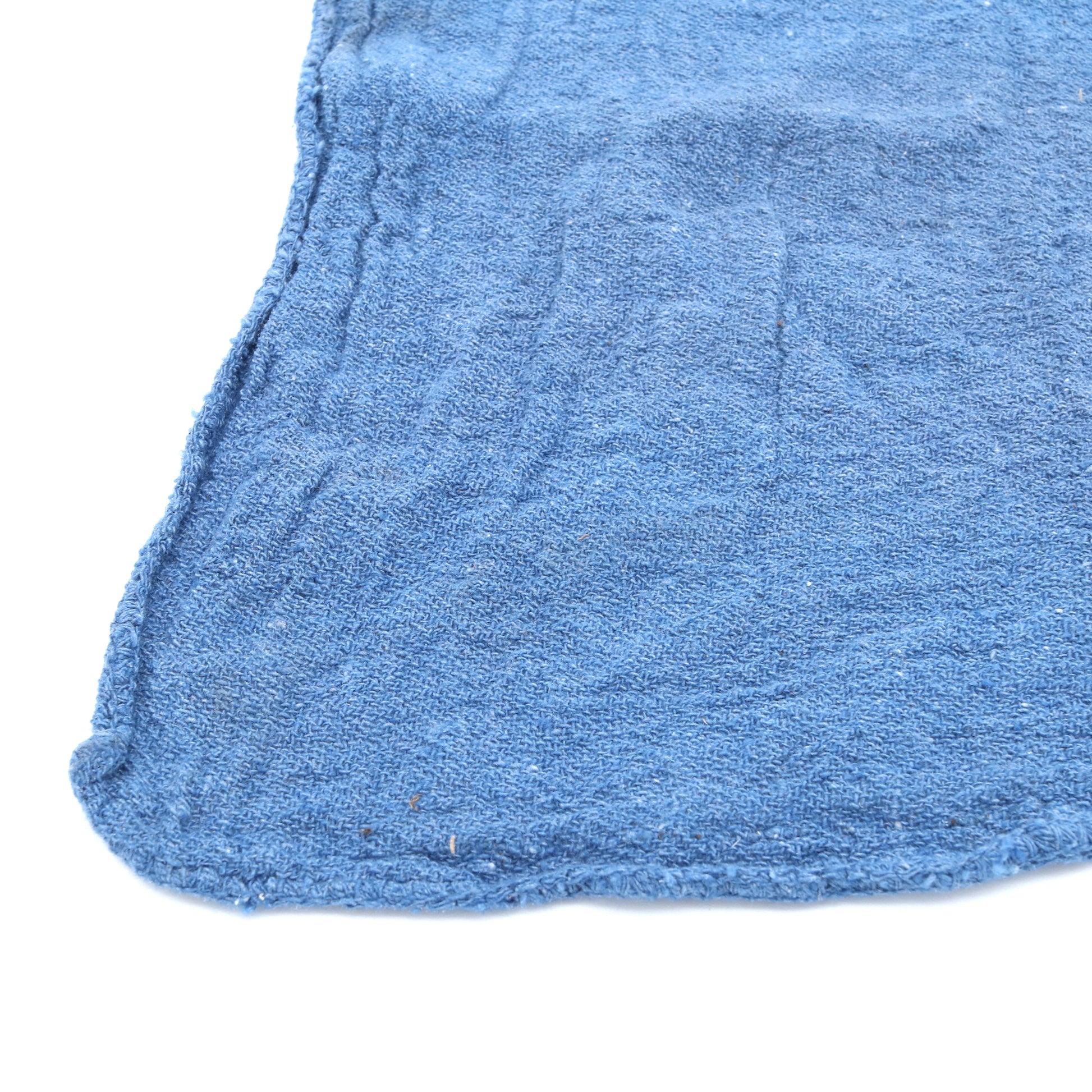Close-up of a blue towel with a white background