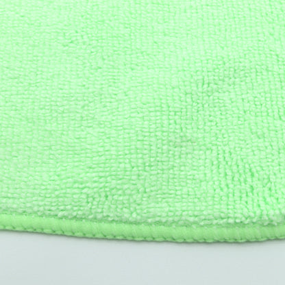 Close-up of a green microfiber cloth on a gray background