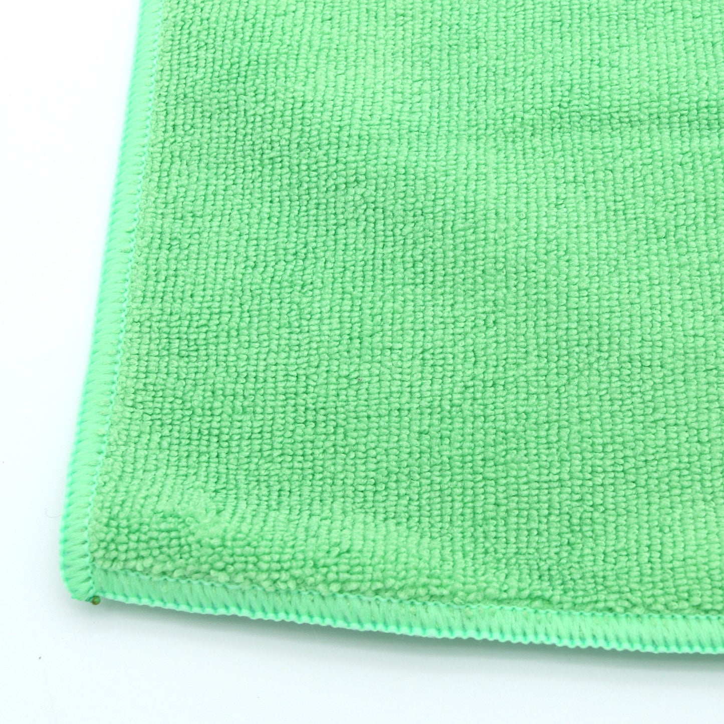 Close-up of a green microfiber cloth on a white background