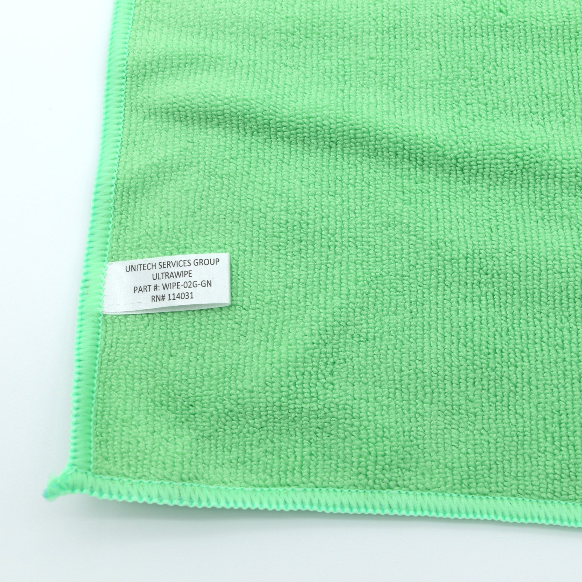 Green microfiber cloth with a label on a white background