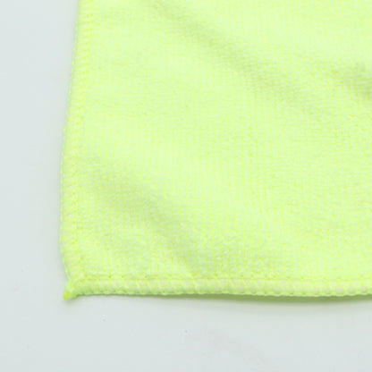 Close-up of a bright yellow textured fabric on a light gray background