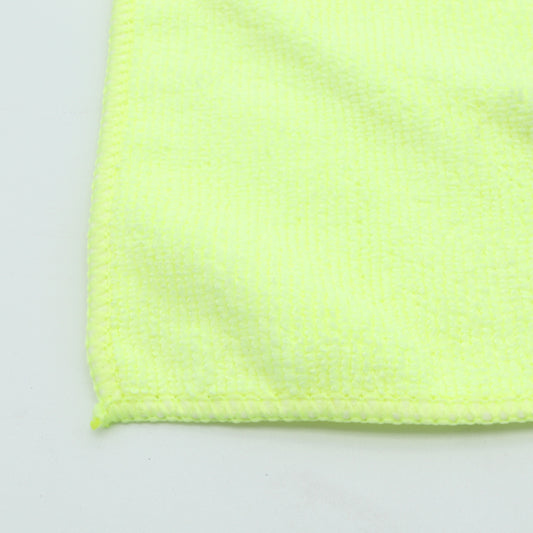 Close-up of a bright yellow textured fabric on a light gray background