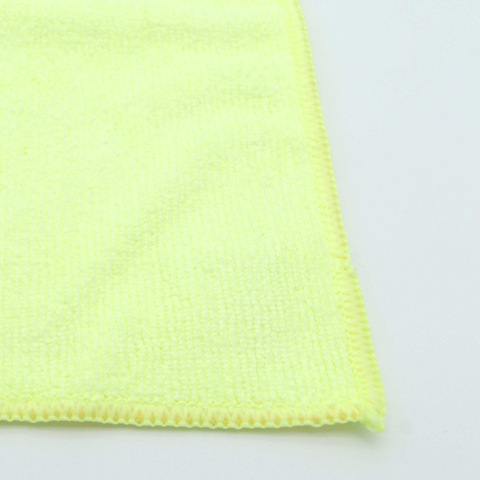 Close-up of a yellow microfiber cloth on a white background