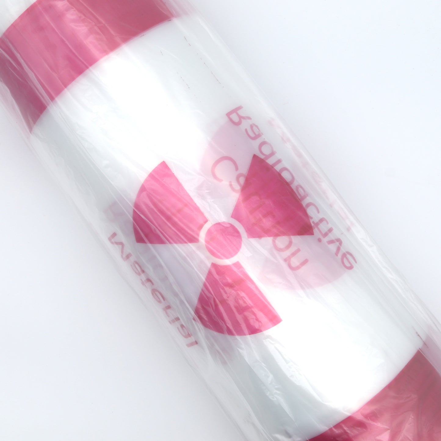 Pink and white bags with a radiation symbol on a light gray background