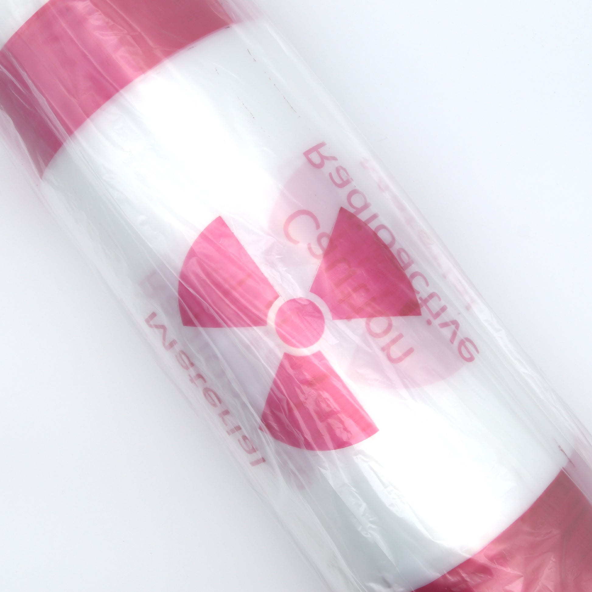 Pink and white bags with a radiation symbol on a light gray background
