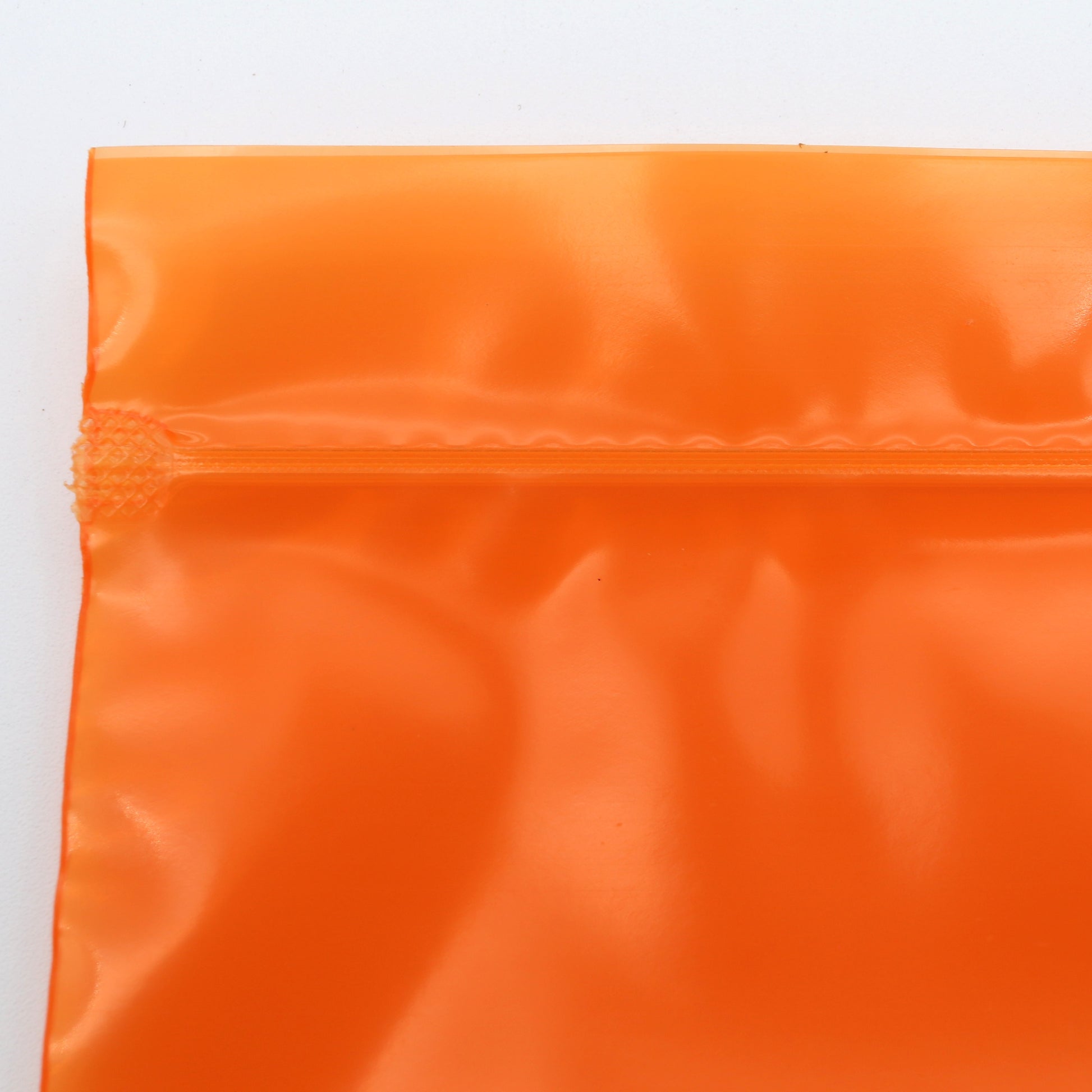 Close-up of an orange reflective material on a white background