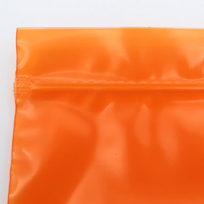 Close-up of an orange reflective material on a white background