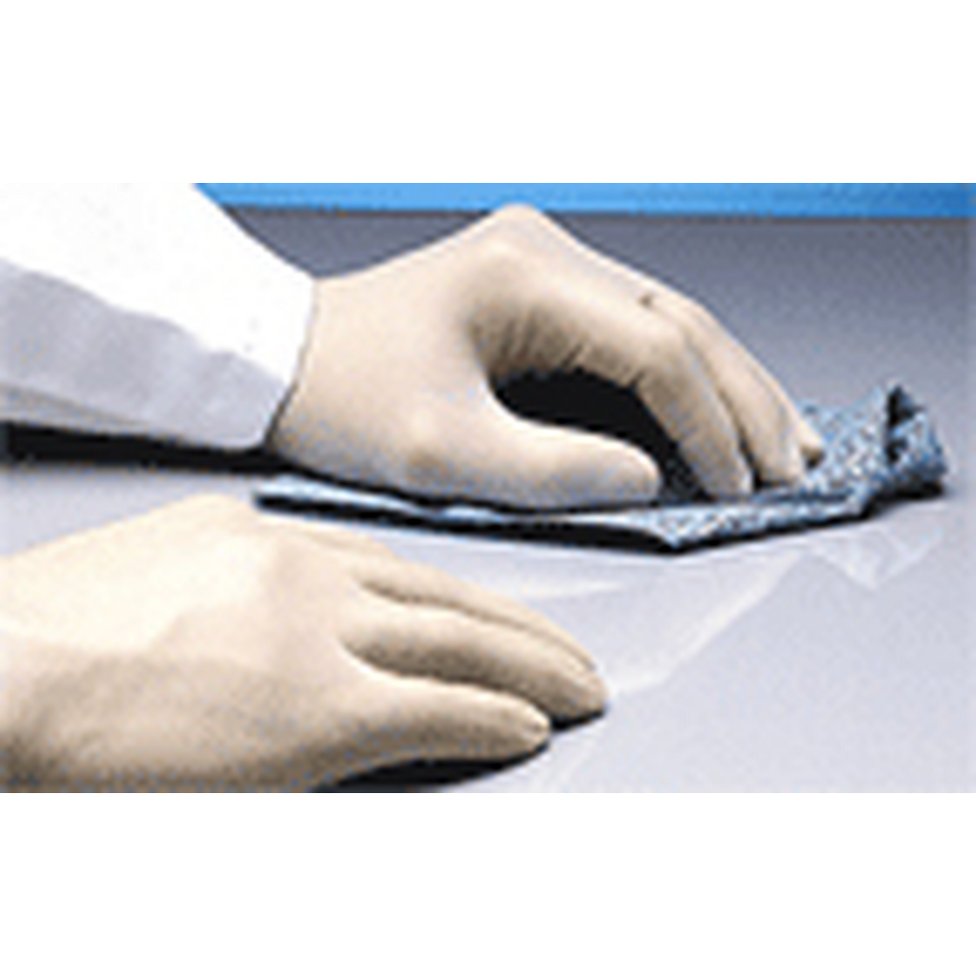 Hands wearing gloves cleaning a surface with a cloth