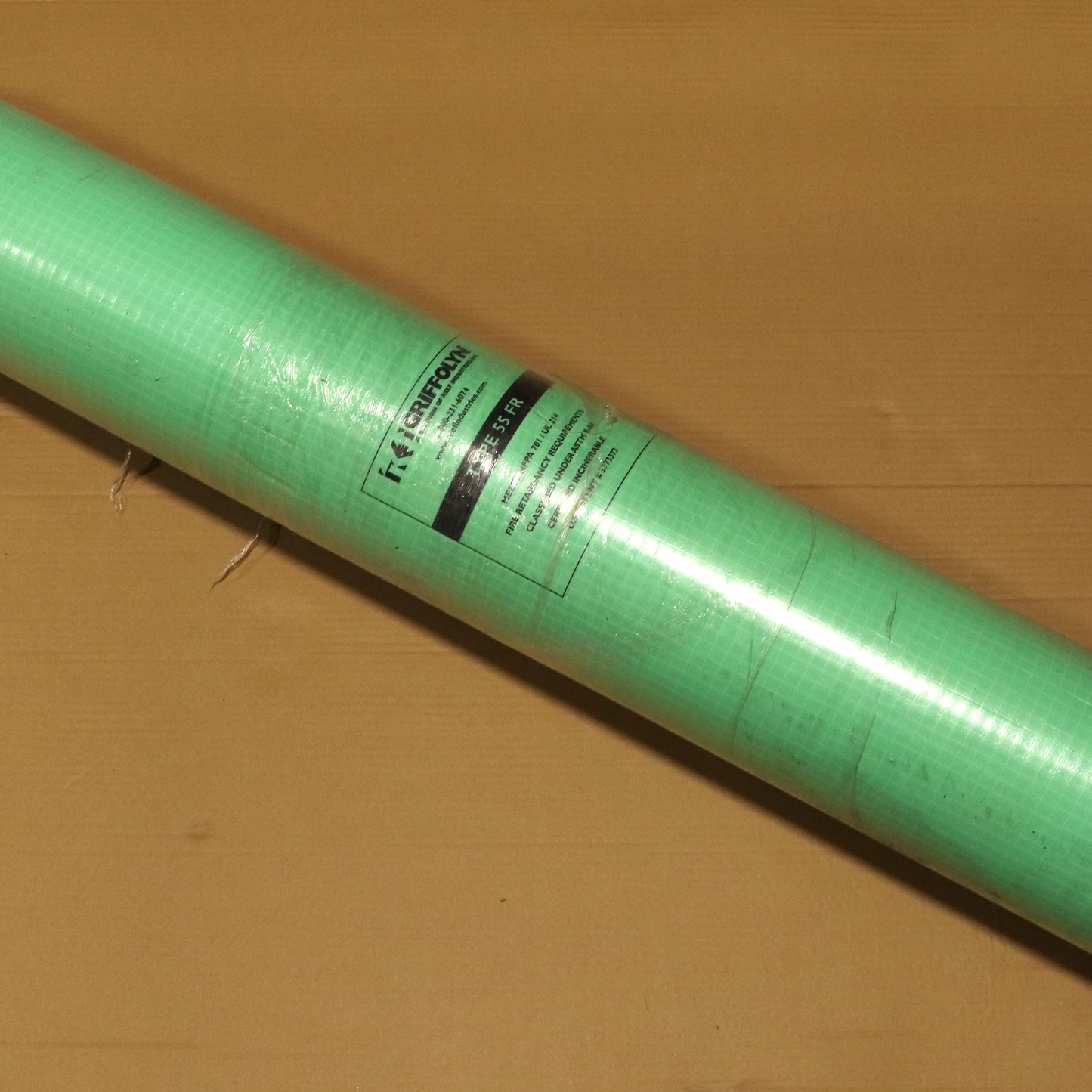 Roll of green paper on a brown surface