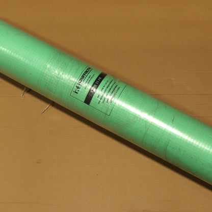 Roll of green paper on a brown surface