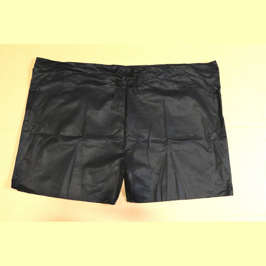 Black scrub shorts on a beige background
