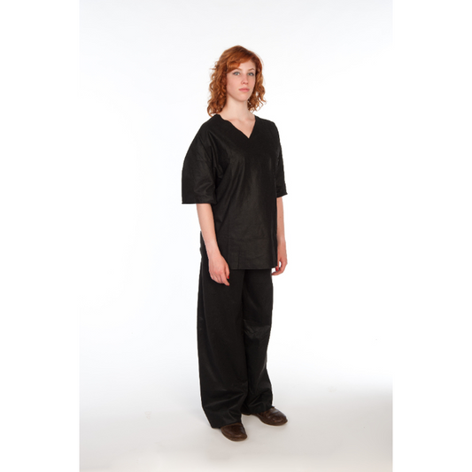 Person wearing black scrubs with a white background
