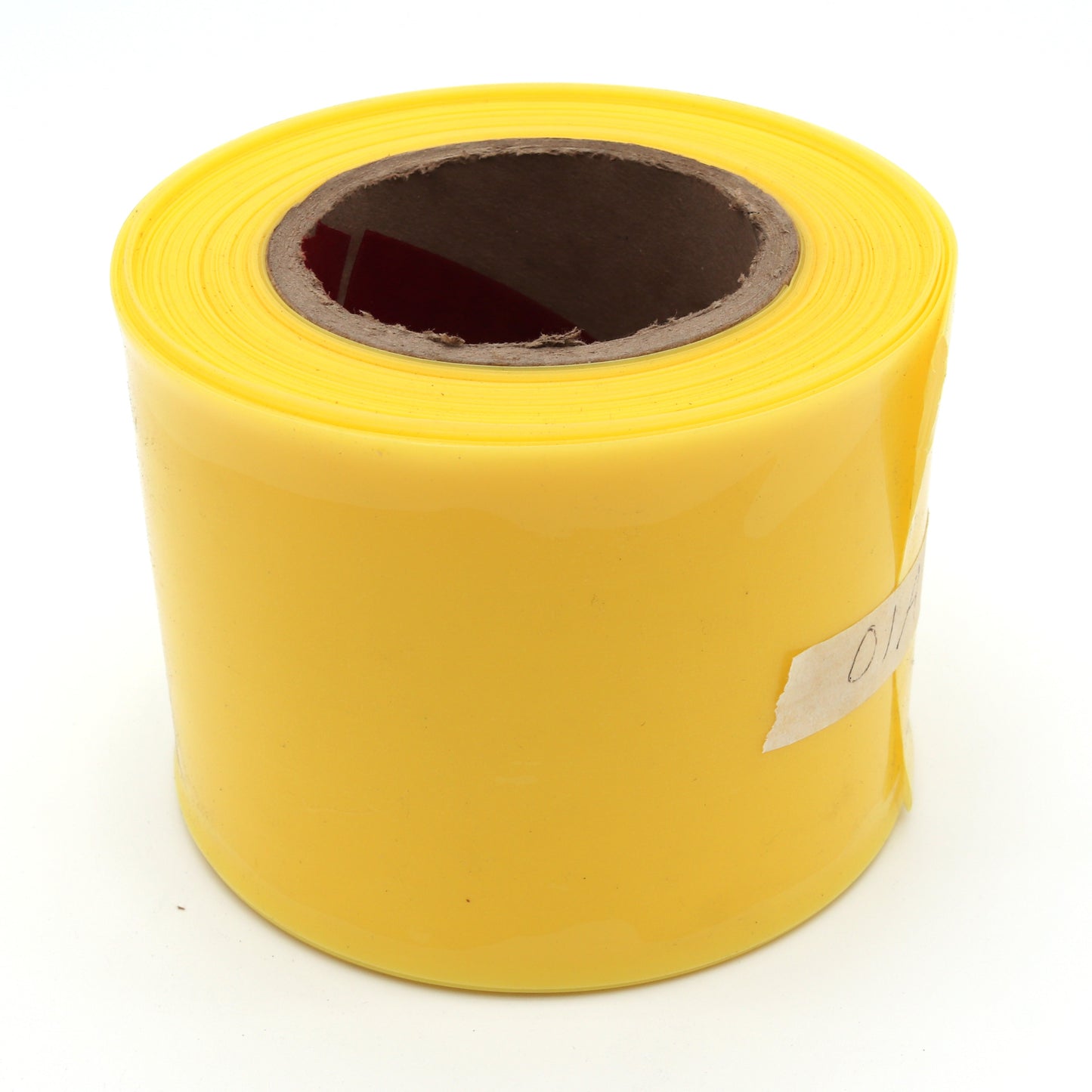 Yellow roll of flagging tape on a white background