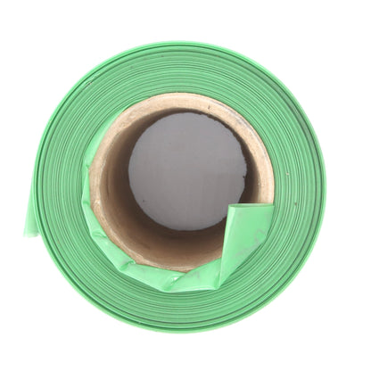 Roll of green flagging tape on a white background