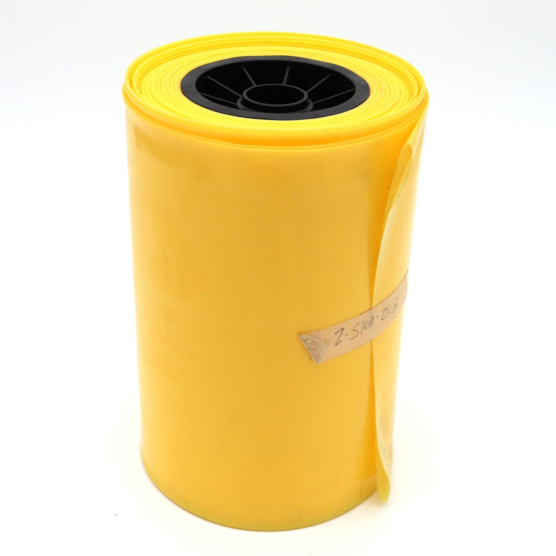 Yellow roll of paper with a black center on a white background